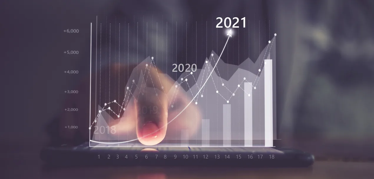 Augmented reality (AR) financial charts showing growing revenue In 2021 floating above digital screen smart phone, businesswoman having meeting about strategy for growth and success